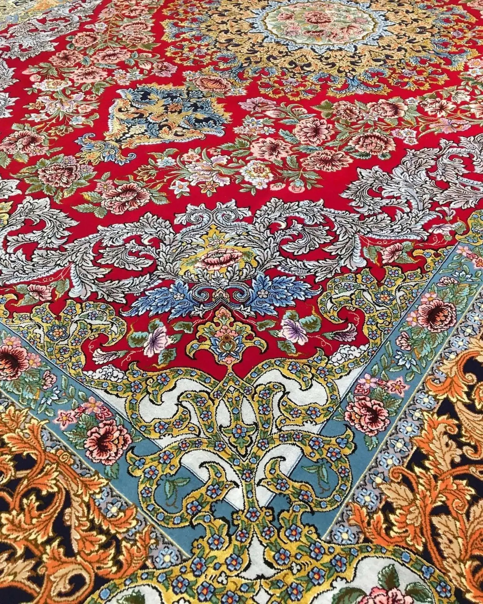 Fine Persian rug in red and gold tones with intricate detailing and hand-knotted texture